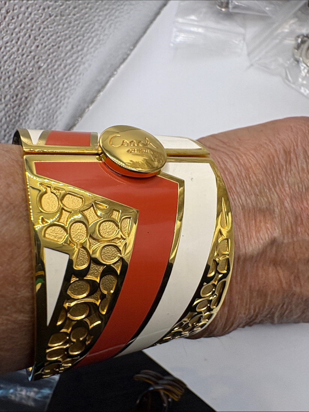 Coach Gold-Tone Cuff Bracelet with Orange and White Enamel